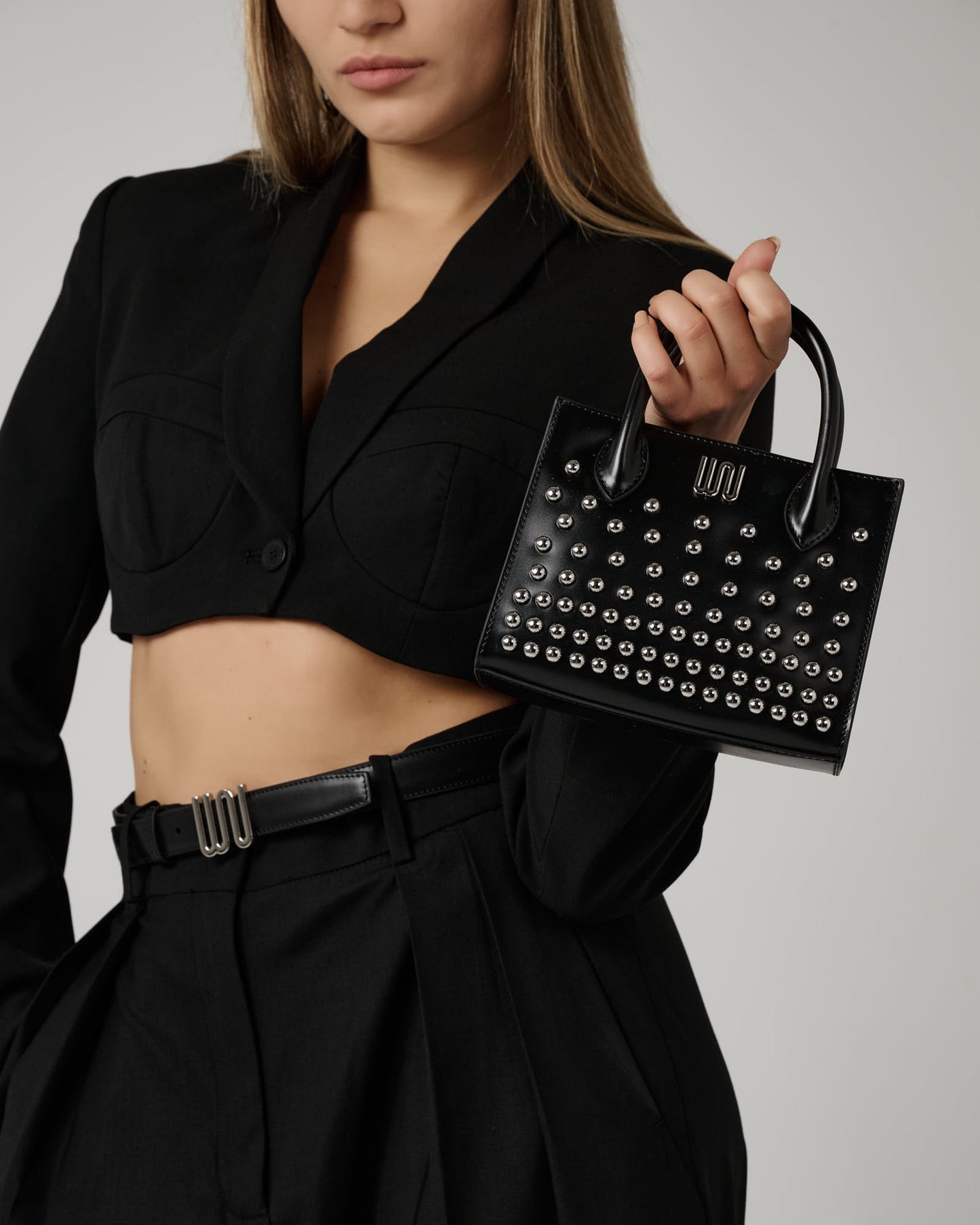 Soladite Noir top handle bag in matte black leather
