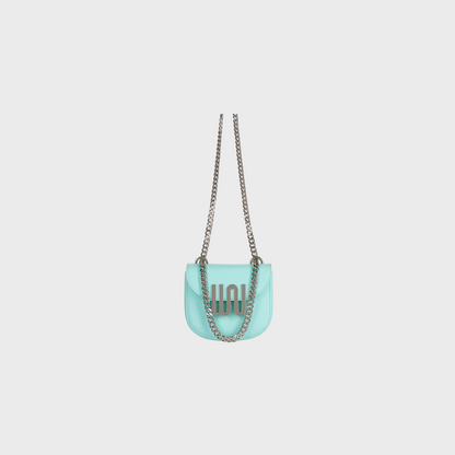Turquoise handbag with a chain strap on a light gray background