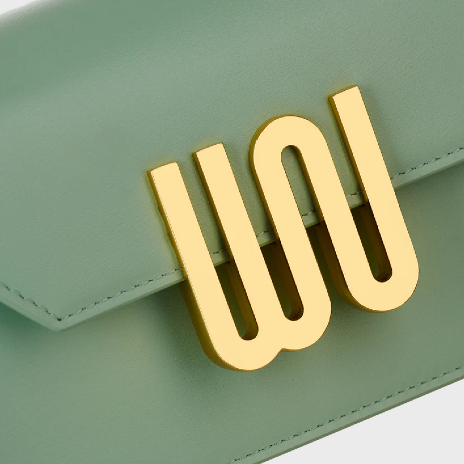 Green wallet with gold 'WO' emblem on a light gray background