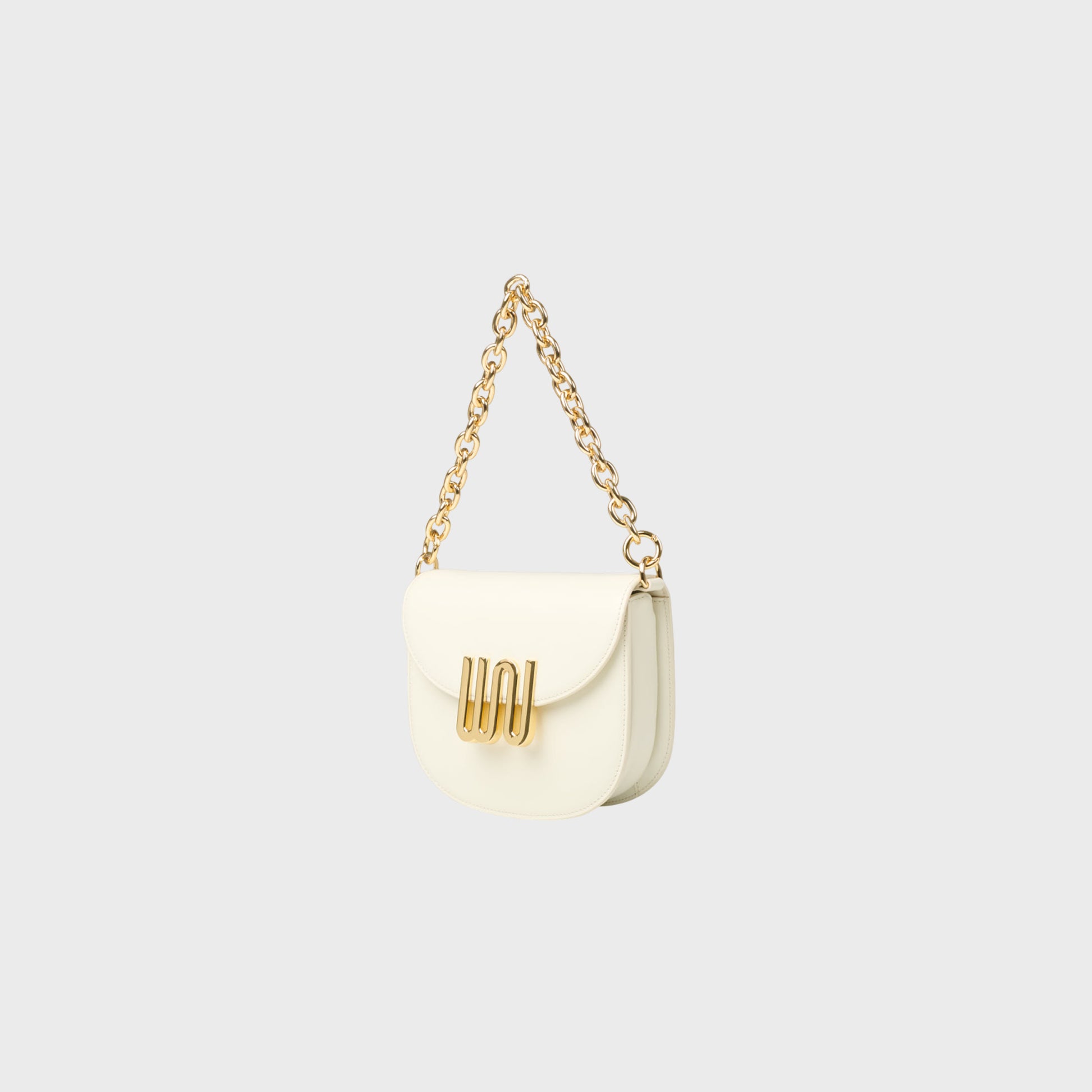 White handbag with gold chain on a light gray background