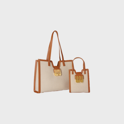 Beige tote bag with brown handles on a light gray background