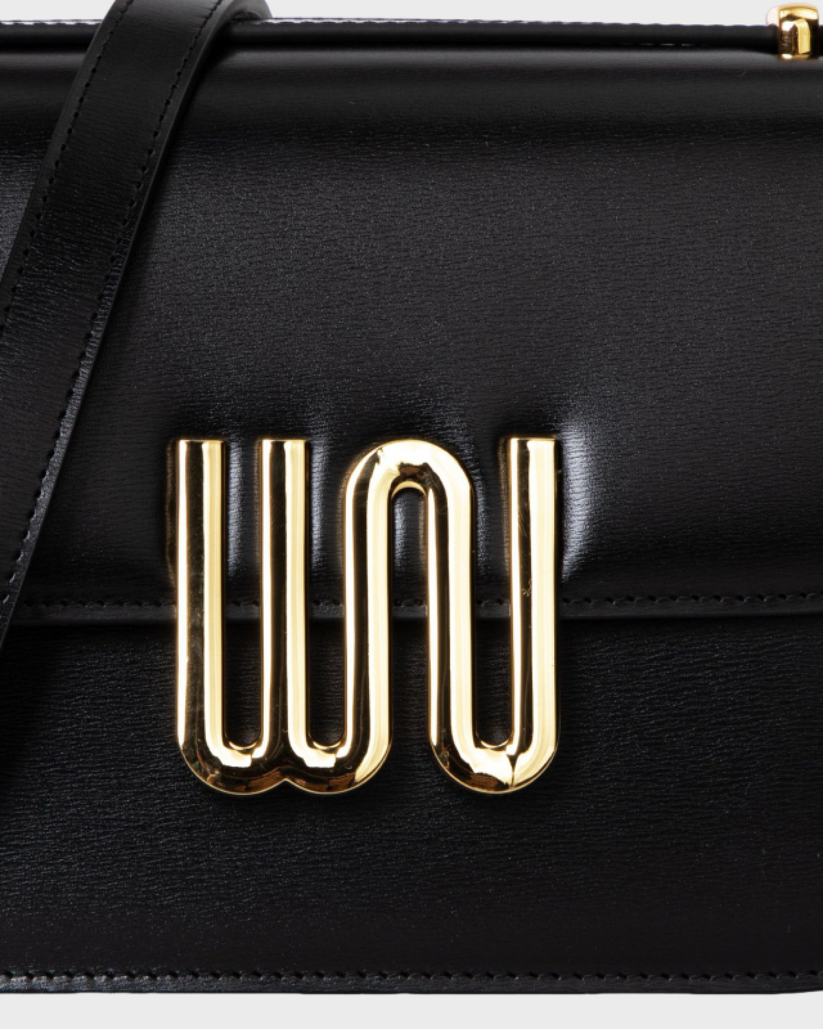 Pyrite Noir gold WN logo close-up