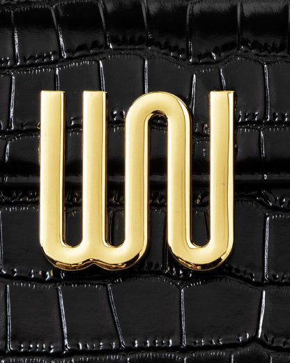 White Noise The Label Bronzite Noir, WN logo hardware close-up on crocodile-embossed leather