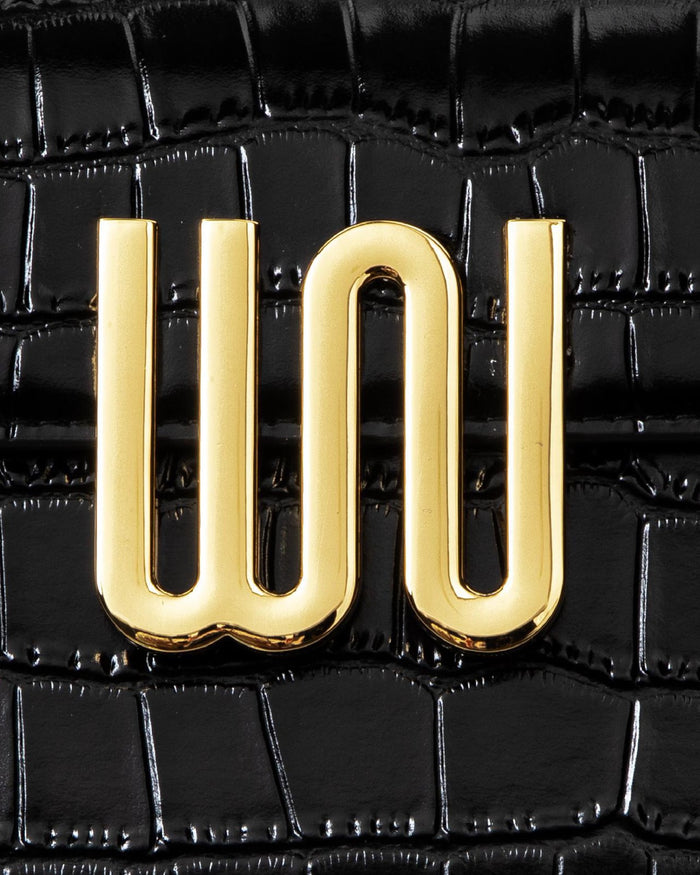 White Noise The Label Bronzite Noir, WN logo hardware close-up on crocodile-embossed leather