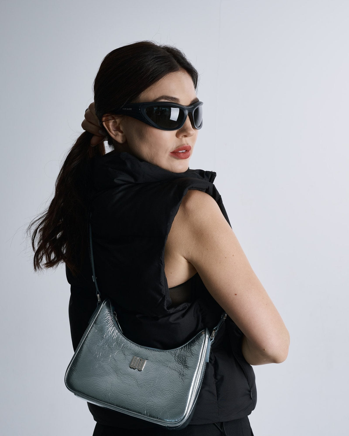 Onyx Aqua, an ice-blue shoulder bag worn with black