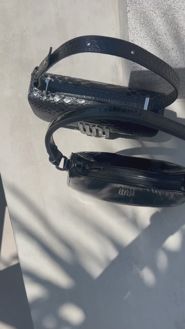 A refined selene black shoulder bag with hand-cut python-embossed leather and transformative versatility.