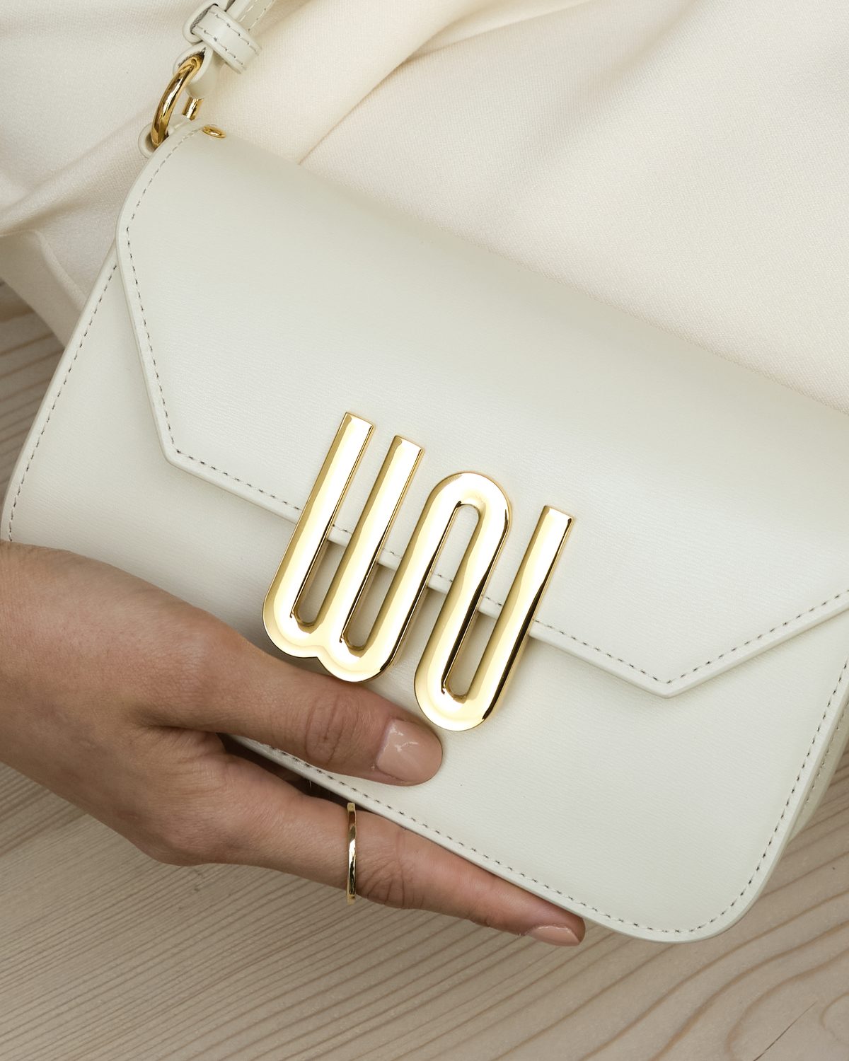 Close on the gold WN hardware on cream leather