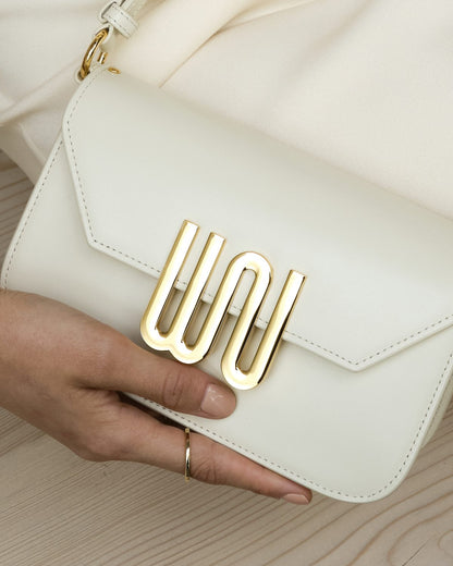 Close on the gold WN hardware on cream leather